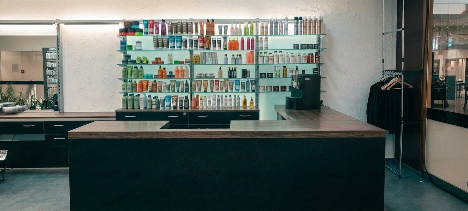 The shelf wall in Sadik's salon with hair care products